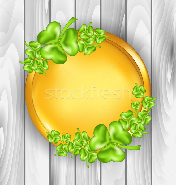 Golden coin with shamrocks. St. Patrick's day symbol, wooden tex Stock photo © smeagorl