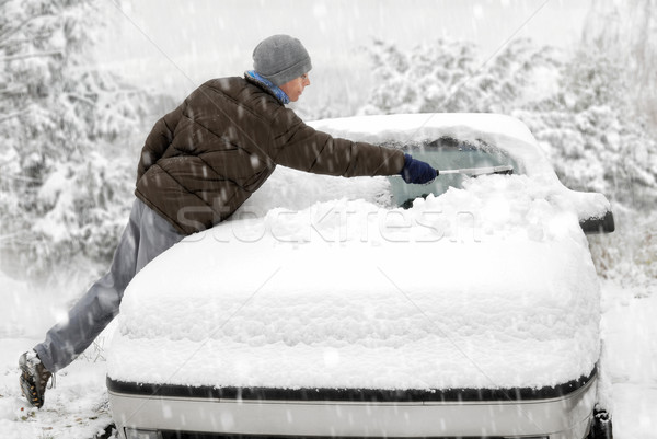 Man brushes snow off his car Stock photo © Smileus