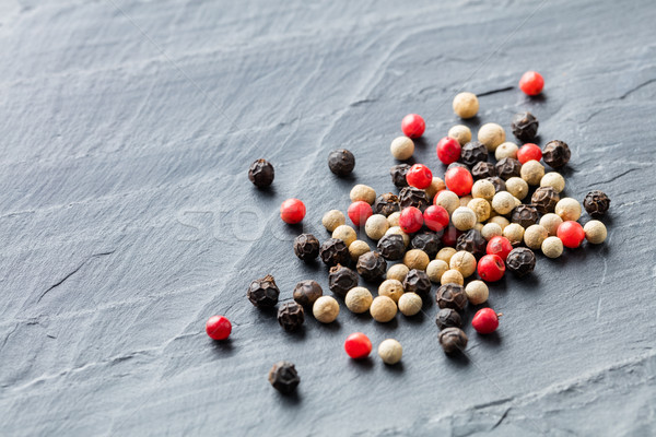 Colorful peppercorn on stone background Stock photo © smuay
