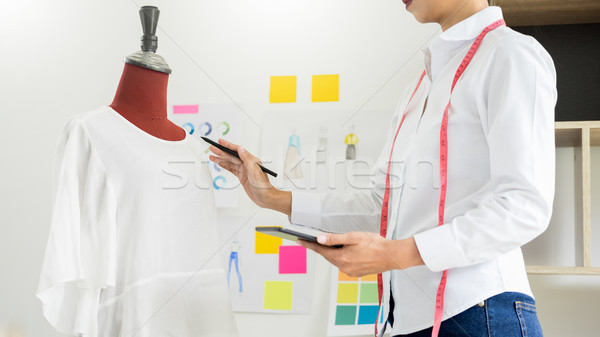 Stylish fashion designer working with measure red dummy as sketc Stock photo © snowing