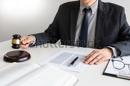 Male Judge lawyer In A Courtroom Striking The Gavel on sounding  Stock photo © snowing