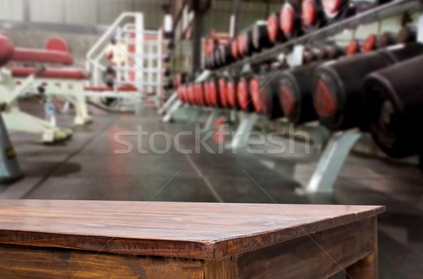 Wooden table on blurred background of fitness gym interior of mo Stock photo © snowing