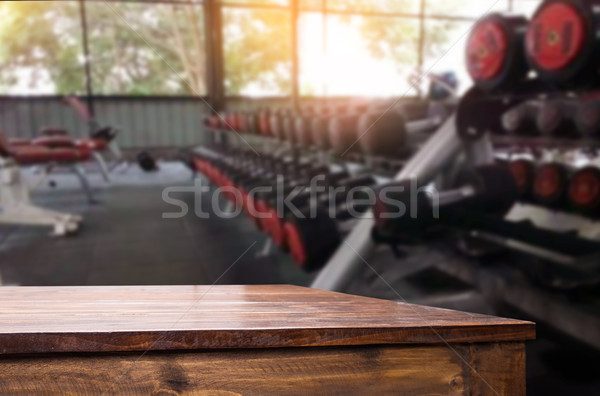 Wooden table on blurred background of fitness gym interior of mo Stock photo © snowing