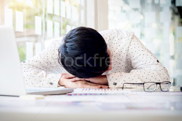  tired businessman sleeping while calculating expenses at desk i Stock photo © snowing
