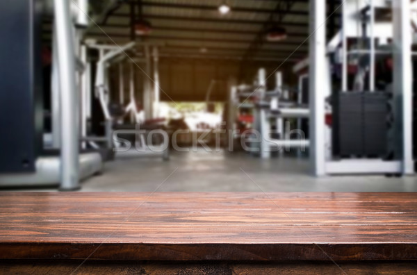 Wooden table on blurred background of fitness gym interior of mo Stock photo © snowing