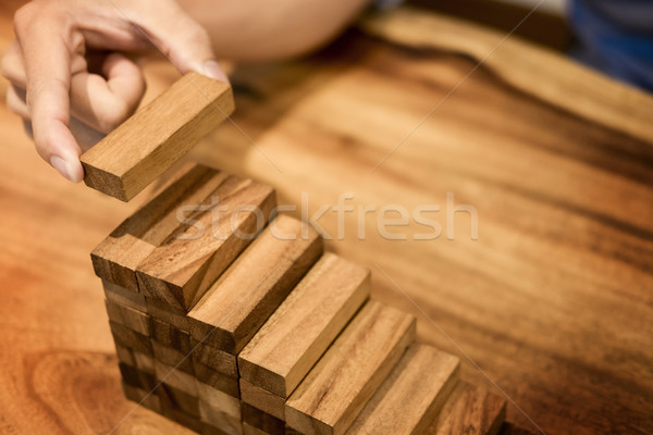 Business man hand put wooden blocks arranging stacking for devel Stock photo © snowing