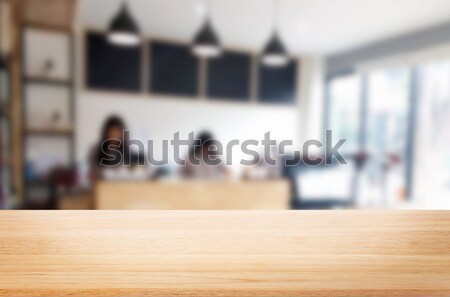 Stock photo: Selected focus empty brown wooden table and Coffee shop blur bac