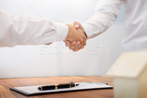 Estate agent shaking hands with customer after contract signatur Stock photo © snowing