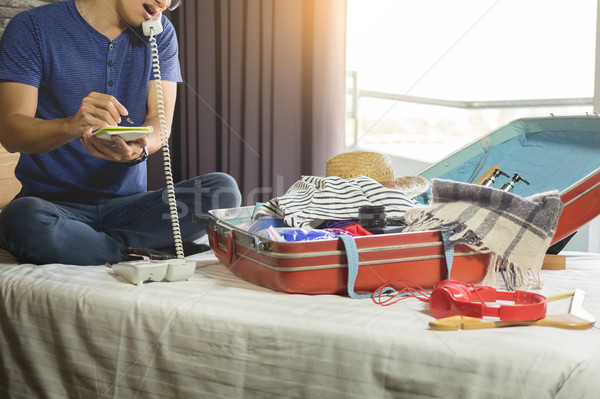 Young man hurring up to meeting and talking by phone and taking  Stock photo © snowing