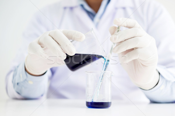 scientists and scientific equipment Pouring mixing reagents liqi Stock photo © snowing