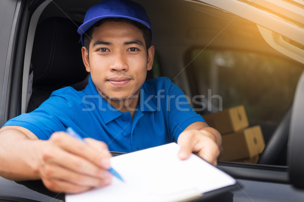 Delivery man checking document list on clipboard outdoor and Car Stock photo © snowing