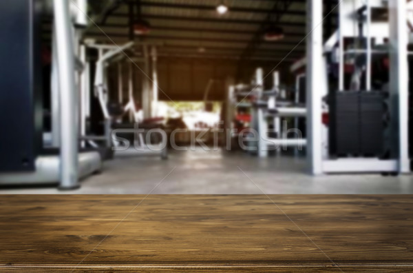 Wooden table on blurred background of fitness gym interior of mo Stock photo © snowing