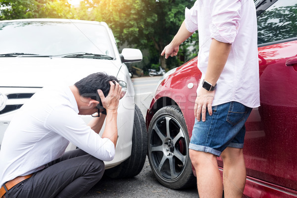 Two men arguing after a car accident Traffic Collision on the ro Stock photo © snowing