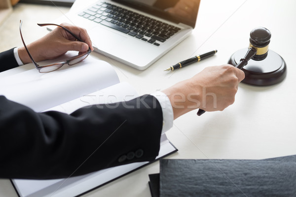 Male Judge lawyer In A Courtroom Striking The Gavel on sounding  Stock photo © snowing