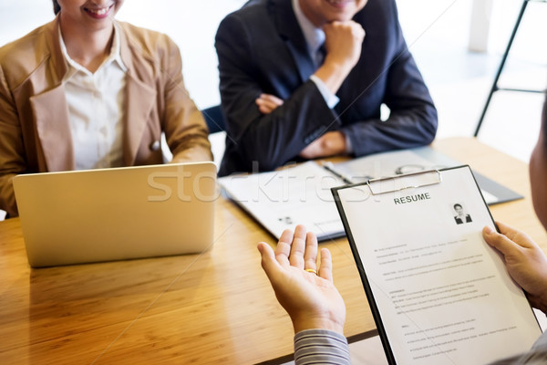 young man explaining about his profile to business managers sitt Stock photo © snowing