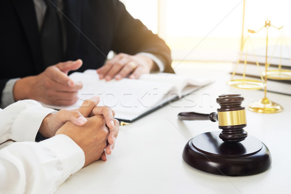 business people and lawyers discussing contract papers sitting a Stock photo © snowing