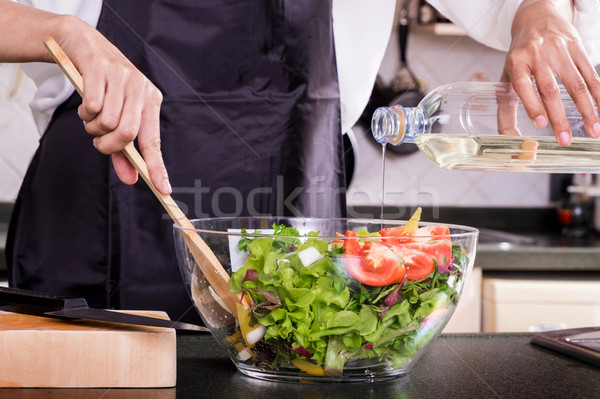 Healthy Woman makes fresh vegetable salad with olive oil, tomato Stock photo © snowing