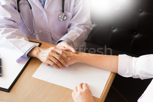 patient listening intently to a male doctor explaining patient s Stock photo © snowing