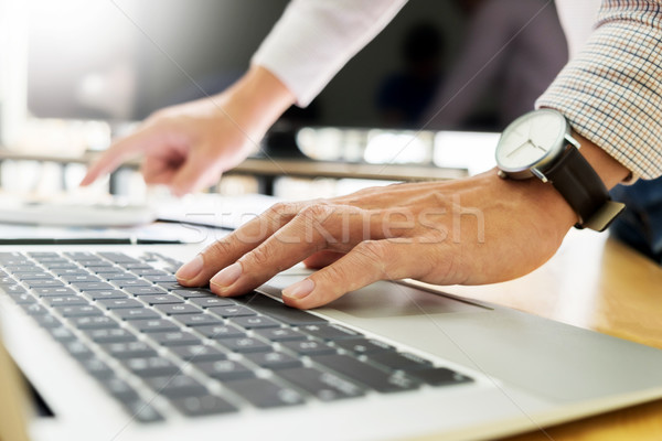 business men working on wooden desk(table) with notebook compute Stock photo © snowing