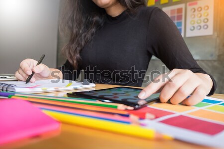 young women working as fashion designer drawing sketches for clo Stock photo © snowing