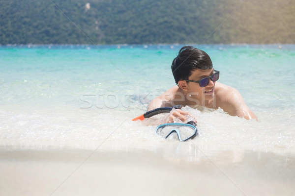 Man relaxing on the beach in vacations with sunset and blue sky  Stock photo © snowing