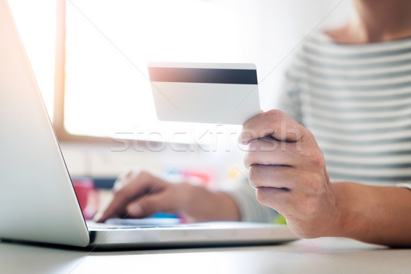 Online shopping concept. hand of happy young holding smartphone  Stock photo © snowing