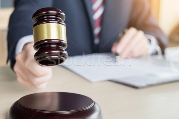 Male Judge In A Courtroom Striking The Gavel on sounding block Stock photo © snowing