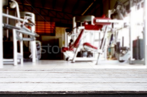 Wooden table on blurred background of fitness gym interior of mo Stock photo © snowing