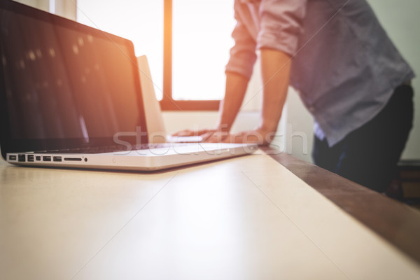 Young adult business man typing using laptop in office Stock photo © snowing