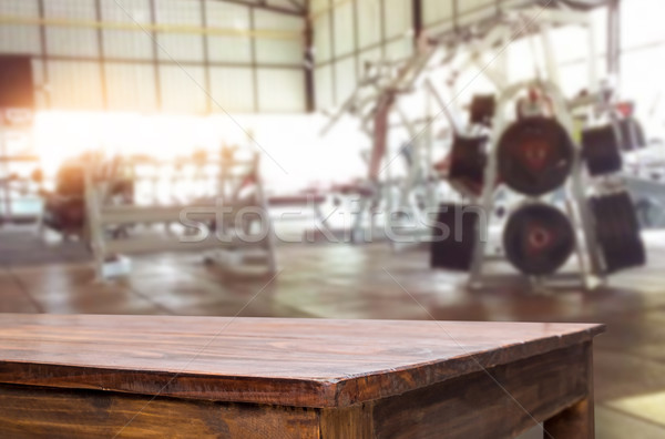 Wooden table on blurred background of fitness gym interior of mo Stock photo © snowing