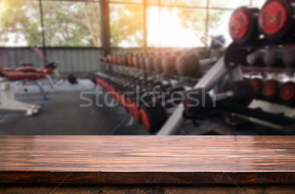 Wooden table on blurred background of fitness gym interior of mo Stock photo © snowing