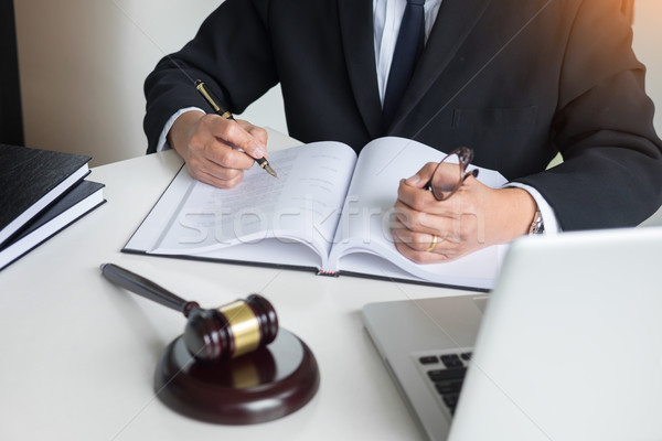 Stock photo: lawyer hand writes the document in court (justice, law) with sou