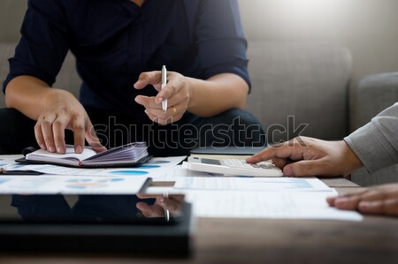 Group of successful business people discussing paperwork and usi Stock photo © snowing