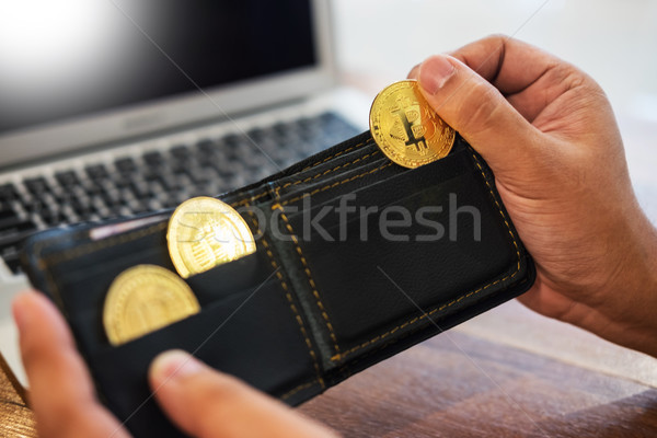 hand with golden metal Bitcoin crypto currency investment- symbo Stock photo © snowing