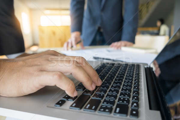 Closeup of businessman is keyboarding on portable net-book, whil Stock photo © snowing