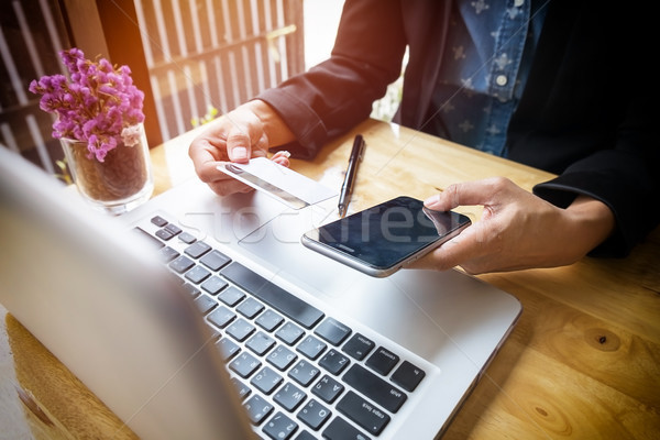 Cropped image of woman inputting card information and key on pho Stock photo © snowing