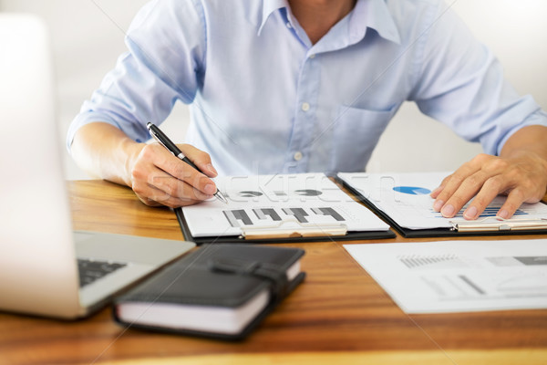 business men working on wooden desk(table) with notebook compute Stock photo © snowing