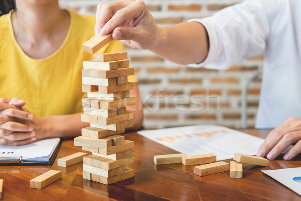 Group of business creative people building tower by wooden block Stock photo © snowing