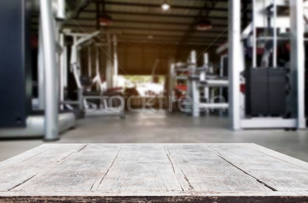 Wooden table on blurred background of fitness gym interior of mo Stock photo © snowing