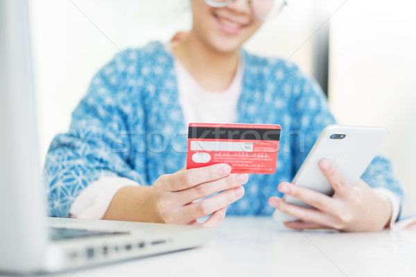 Online shopping concept. hand of happy young holding smartphone  Stock photo © snowing