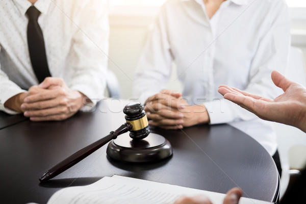 business people and lawyers discussing contract papers sitting a Stock photo © snowing