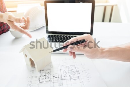 Stock photo: Architects engineer discussing at the table with blueprint - Clo