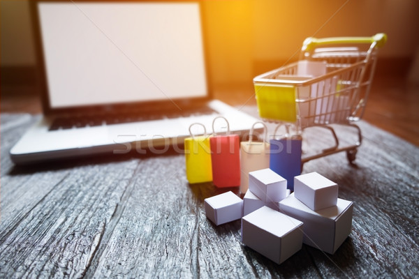 laptop blank screen and hopping cart full of gifts with copyspac Stock photo © snowing