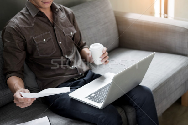Handsome Young Man Sitting on the Living Room Couch, Casual youn Stock photo © snowing