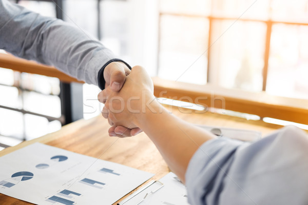 Stock photo: Two confident business man shaking hands during a meeting in the