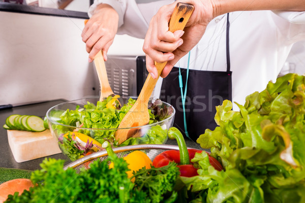 Healthy Woman makes fresh vegetable salad with olive oil, tomato Stock photo © snowing