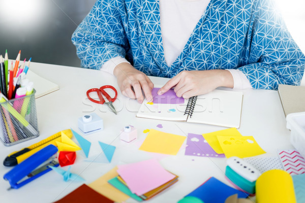 Woman's hand cut paper Making a scrap booking or other festive d Stock photo © snowing