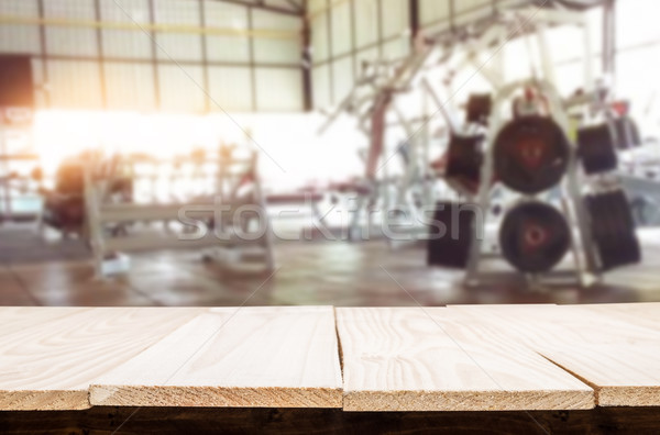 Wooden table on blurred background of fitness gym interior of mo Stock photo © snowing