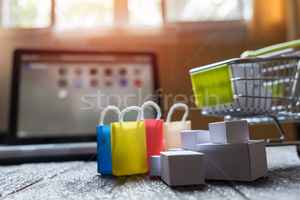 laptop blank screen and hopping cart full of gifts with copyspac Stock photo © snowing