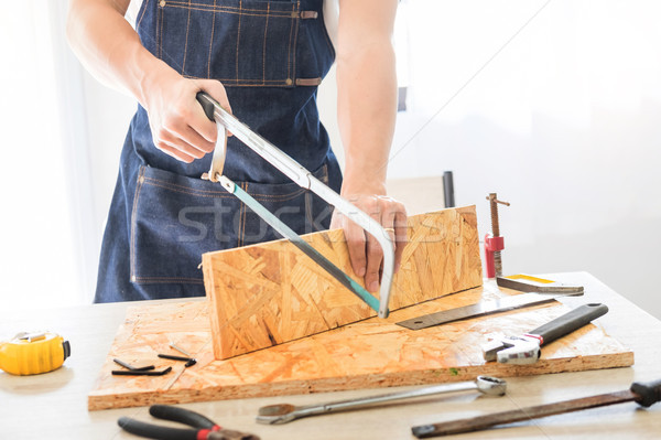 Carpenter working carefully looking at the plans work in carpent Stock photo © snowing